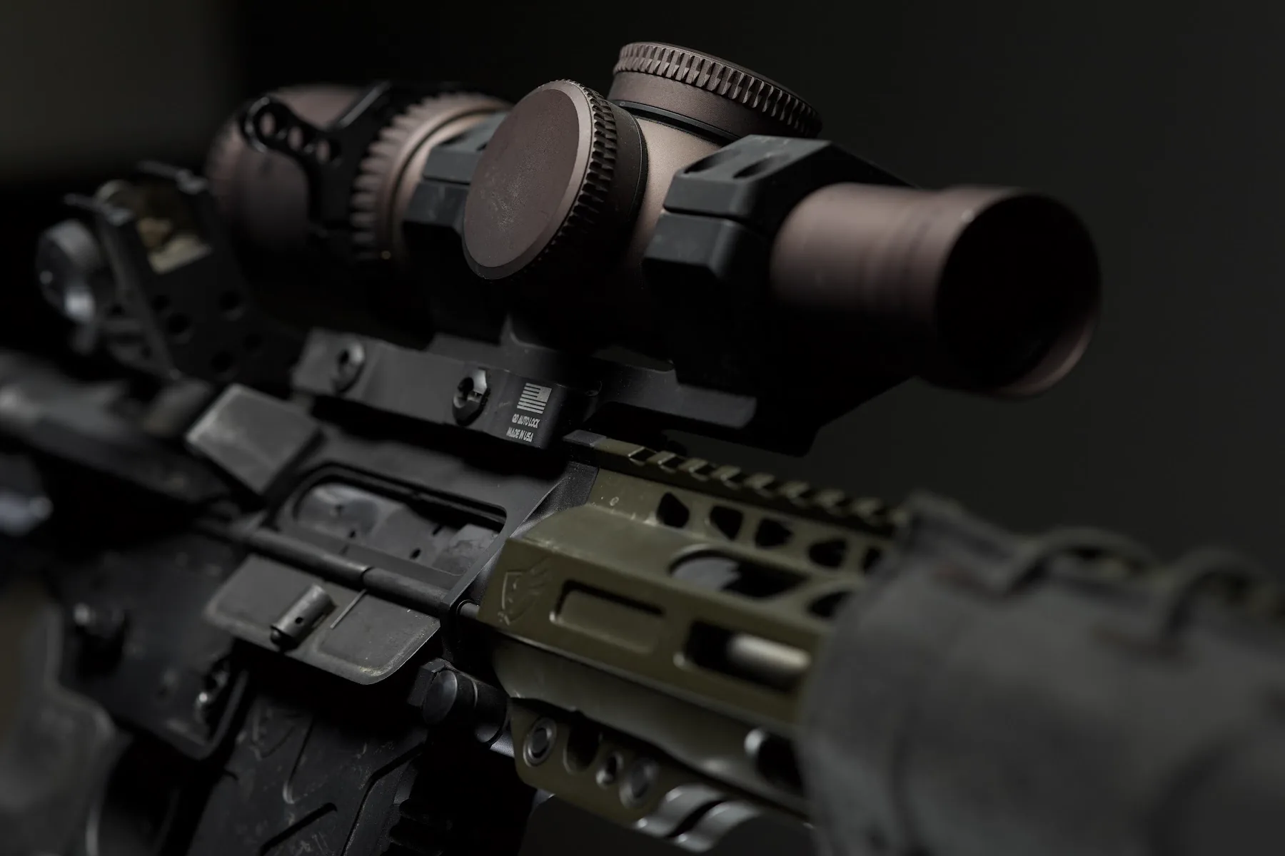 Close-up product photograph of a rifle optic