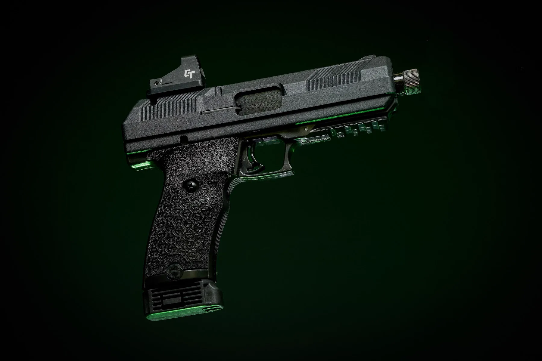 Custom pistol photographed against a deep green background