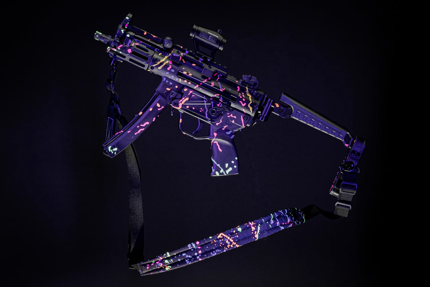 Purple patterned firearm photographed on black